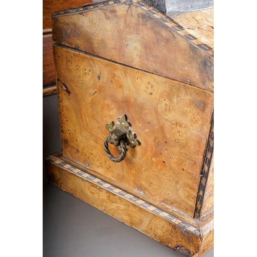 576 - An early 19th century oak and stained pine candle box of rectangular form with sloped hinged lid and... 