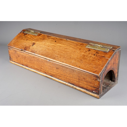 576 - An early 19th century oak and stained pine candle box of rectangular form with sloped hinged lid and... 