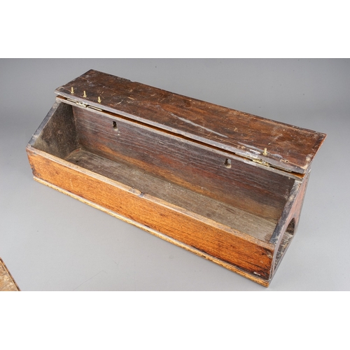 576 - An early 19th century oak and stained pine candle box of rectangular form with sloped hinged lid and... 