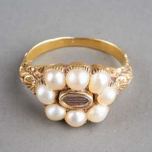 585 - A 19th century gold and pearl mourning ring, set with eight pearls surrounding a plait of hair, chas... 