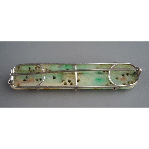 586 - An Art Deco jade rectangular brooch, pierced jade depicting fruit and foliage, set in white metal, a... 