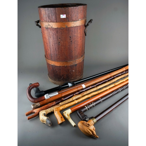 591 - A stained wood brass bound two handled umbrella  stick stand together with a collection of walking s... 