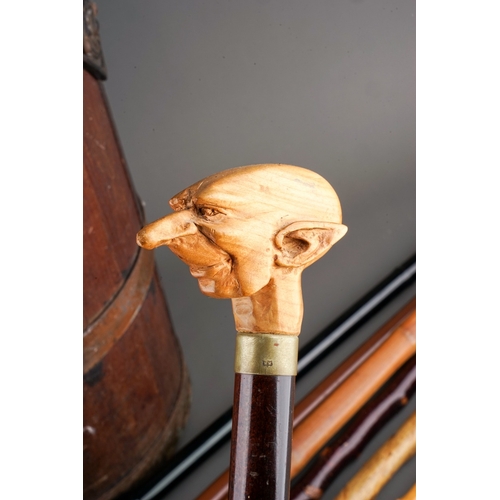 591 - A stained wood brass bound two handled umbrella  stick stand together with a collection of walking s... 