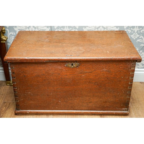 592 - A Victorian stained pine blanket chest with hinged cover, dove tail construction with brass escutche... 