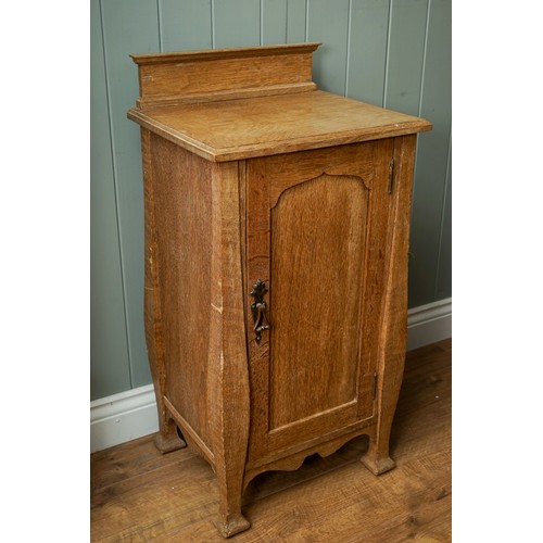 594 - An Arts & Crafts pine cabinet, single door, drop handle on shaped supports, approx 77cm high