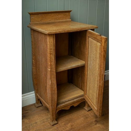 594 - An Arts & Crafts pine cabinet, single door, drop handle on shaped supports, approx 77cm high