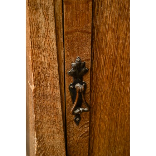 594 - An Arts & Crafts pine cabinet, single door, drop handle on shaped supports, approx 77cm high