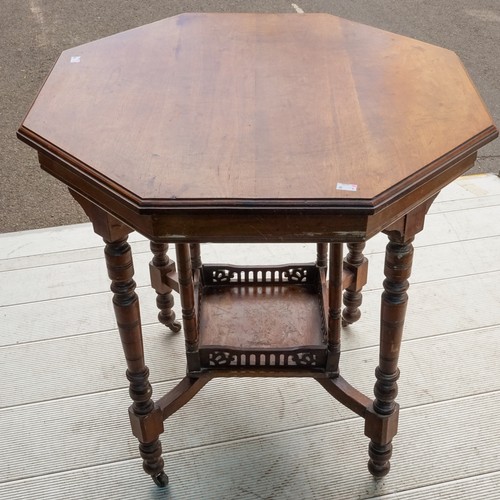 596 - An early 20th Century mahogany occasional table, on turned supports with central tier shelf section,... 