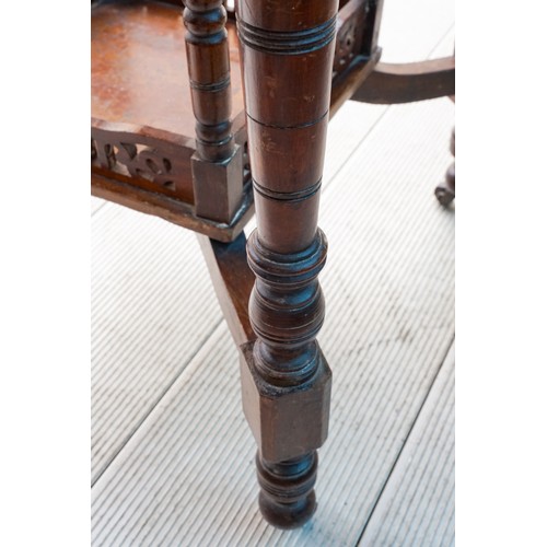 596 - An early 20th Century mahogany occasional table, on turned supports with central tier shelf section,... 