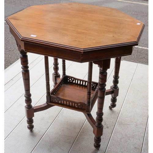 596 - An early 20th Century mahogany occasional table, on turned supports with central tier shelf section,... 