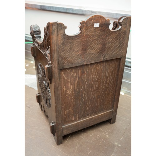 598 - A Victorian Gothic oak combination hall seat and coal skuttle, the fall front carved with Lion`s hea... 