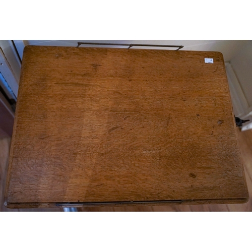 603 - A late 19th Century adjustable cast iron mounted oak tray table, stamped 