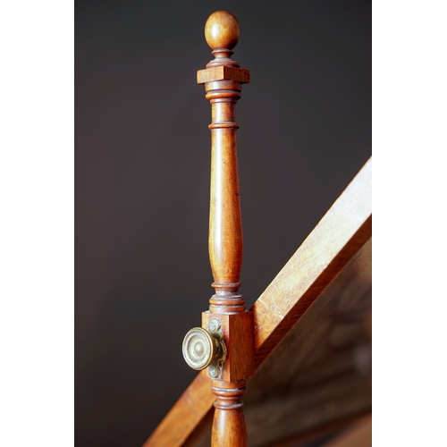 604 - An early 19th Century mahogany framed dressing table mirror, plate on turned supports above shaped b... 