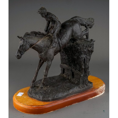 608 - A mid 20th Century English bronzed resin group of a horse and female jockey jumping (Point-to-Point)... 