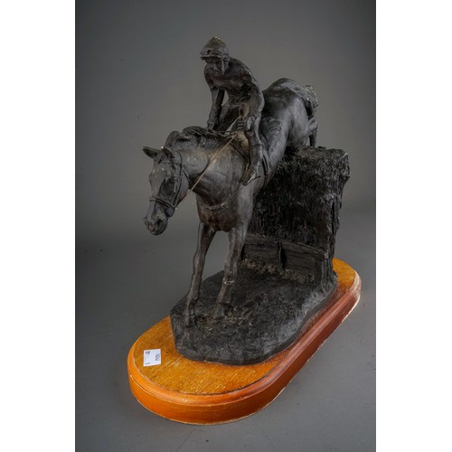 608 - A mid 20th Century English bronzed resin group of a horse and female jockey jumping (Point-to-Point)... 