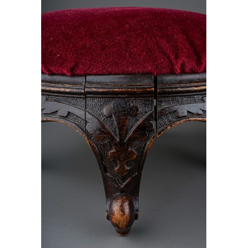 619 - A pair of late Victorian circular walnut footstools, red velvet upholstered inset tops, foliate carv... 