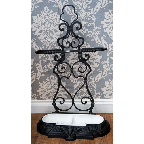 620 - A Victorian cast and wrought iron umbrella stand, scrolled back, removable two division drip tray, s... 