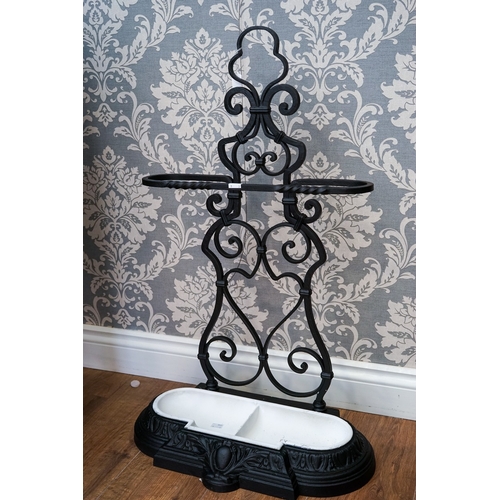 620 - A Victorian cast and wrought iron umbrella stand, scrolled back, removable two division drip tray, s... 