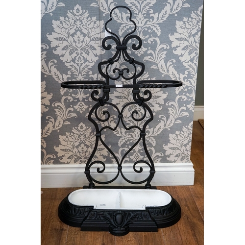 620 - A Victorian cast and wrought iron umbrella stand, scrolled back, removable two division drip tray, s... 