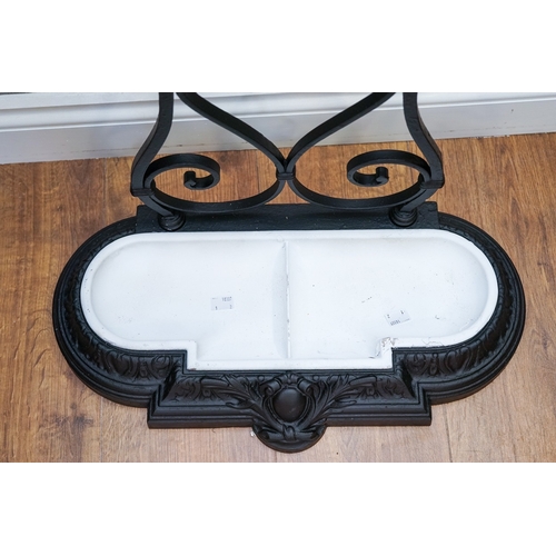 620 - A Victorian cast and wrought iron umbrella stand, scrolled back, removable two division drip tray, s... 