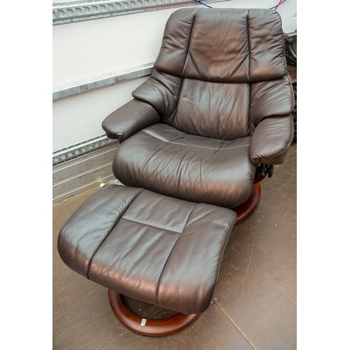 623 - A Stressless brown leather upholstered reclining armchair with matching stool, marked Stressless to ... 