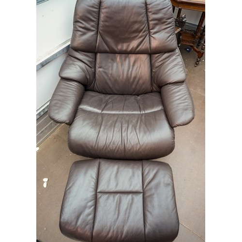 623 - A Stressless brown leather upholstered reclining armchair with matching stool, marked Stressless to ... 