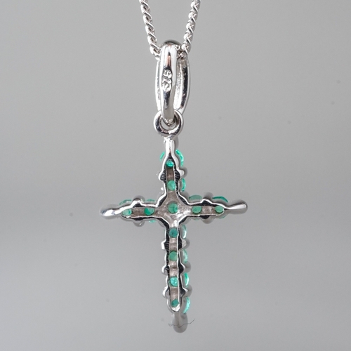 10 - A 9ct white gold and emerald crucifix pendant necklace, set with round-cut emeralds, approx 18mm, on... 