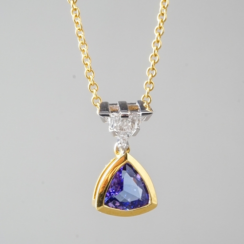 15 - An 18ct yellow gold tanzanite and diamond pendant necklace, set with a triangular-mixed cut tanzanit... 