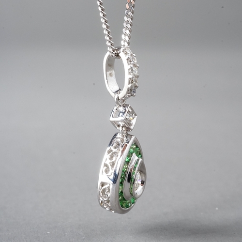 16 - An 18ct white gold diamond and green stone pear shape pendant, set with round brilliant-cut diamonds... 