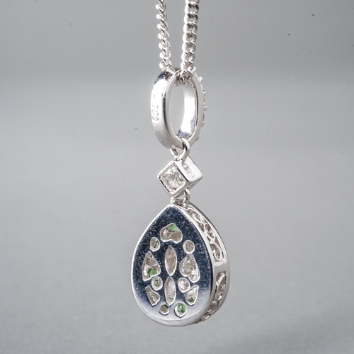 16 - An 18ct white gold diamond and green stone pear shape pendant, set with round brilliant-cut diamonds... 