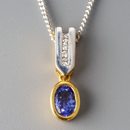 17 - An 18ct yellow and white gold tanzanite and diamond pendant necklace, set with an oval-cut tanzanite... 