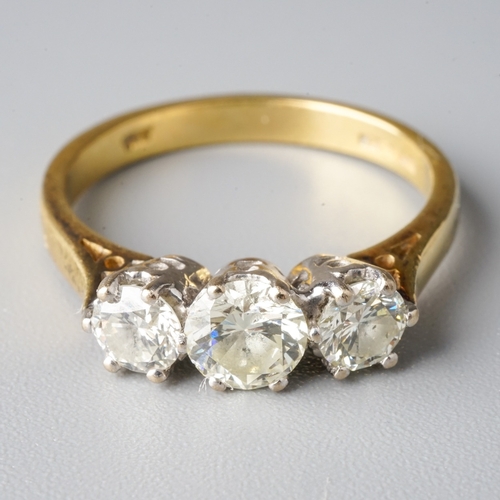 23 - An 18ct yellow gold and diamond three-stone ring, the central round brilliant-cut diamond approx 0.5... 