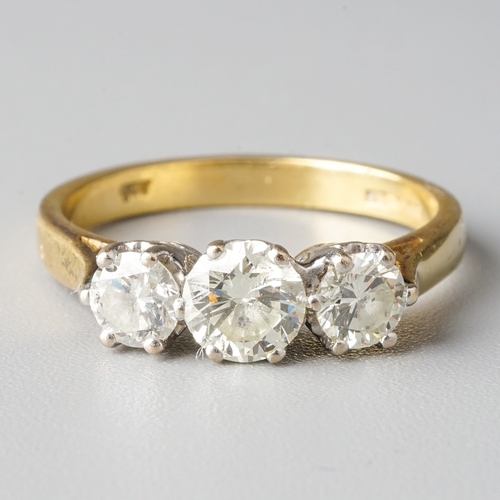 23 - An 18ct yellow gold and diamond three-stone ring, the central round brilliant-cut diamond approx 0.5... 