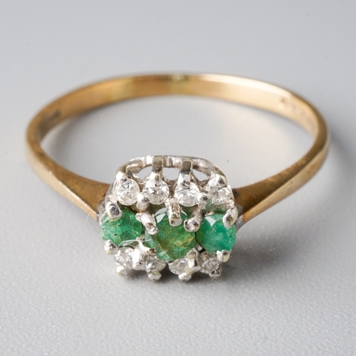 27 - A 9ct yellow gold emerald and diamond ring, set with three round emeralds flanked by eight round bri... 