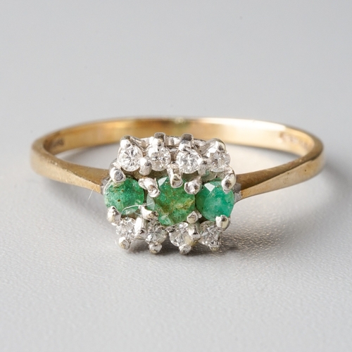 27 - A 9ct yellow gold emerald and diamond ring, set with three round emeralds flanked by eight round bri... 