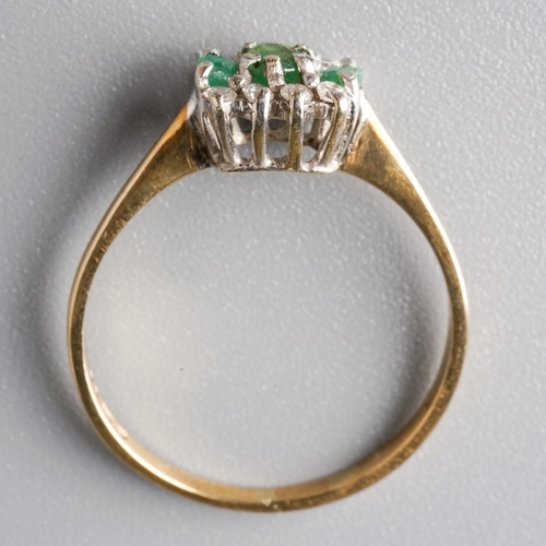 27 - A 9ct yellow gold emerald and diamond ring, set with three round emeralds flanked by eight round bri... 