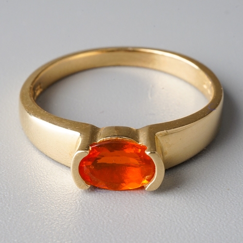 32 - A suite of 14k yellow gold and fire opal, including a ring, size N, a pendant necklace, and a pair o... 