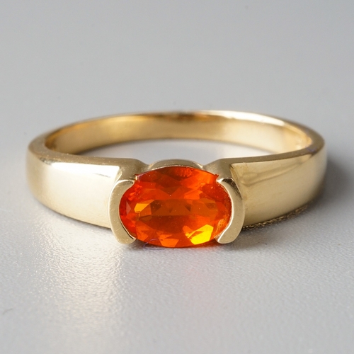 32 - A suite of 14k yellow gold and fire opal, including a ring, size N, a pendant necklace, and a pair o... 