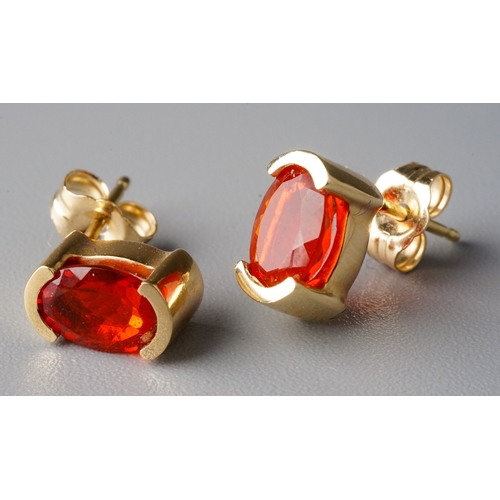 32 - A suite of 14k yellow gold and fire opal, including a ring, size N, a pendant necklace, and a pair o... 