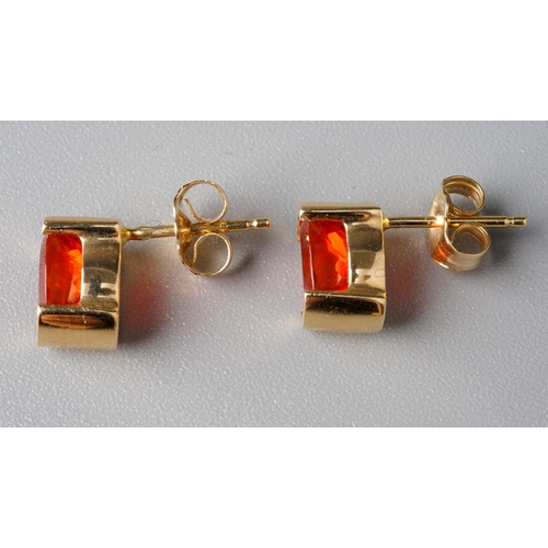 32 - A suite of 14k yellow gold and fire opal, including a ring, size N, a pendant necklace, and a pair o... 