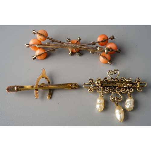 46 - A 9ct yellow gold wishbone brooch, approx 1.1g; a yellow metal coral and seed pearl brooch, approx 5... 