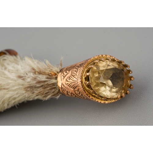 57 - A Victorian Scottish brooch, the grouse foot with 9ct gold mounts set with a citrine coloured stone,... 