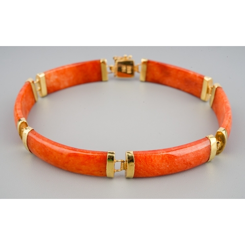 60 - A Chinese 14k yellow gold and orange jade bracelet, approx 7.5cm long, gross weight approx 11.8g