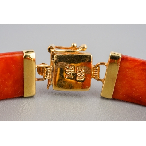 60 - A Chinese 14k yellow gold and orange jade bracelet, approx 7.5cm long, gross weight approx 11.8g