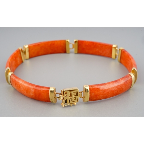 60 - A Chinese 14k yellow gold and orange jade bracelet, approx 7.5cm long, gross weight approx 11.8g