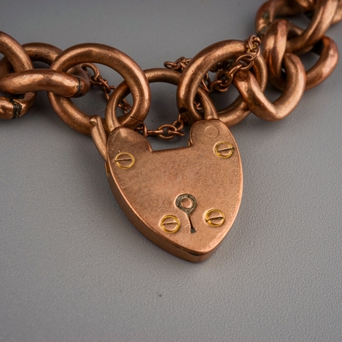 64 - 9 ct gold curb link bracelet with heart padlock, 12.4 g gross weight