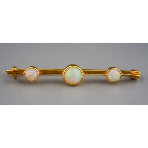 65 - Yellow metal bar brooch set with 3 cabochons opals , gross weight 3.3 g