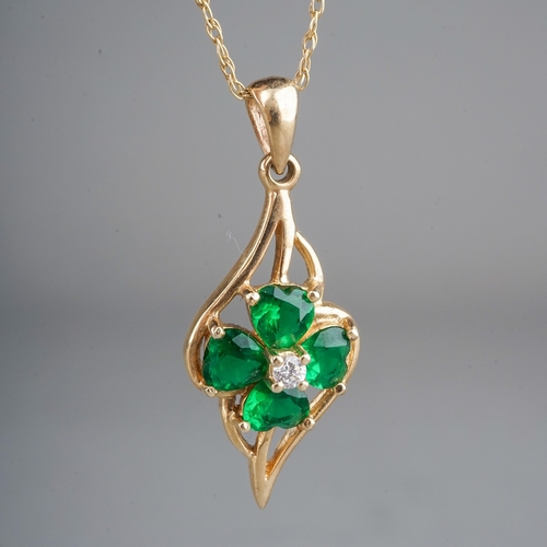 101 - A 9ct yellow gold pendant necklace, set with a CZ surrounded by heart-cut green stones, total gross ... 