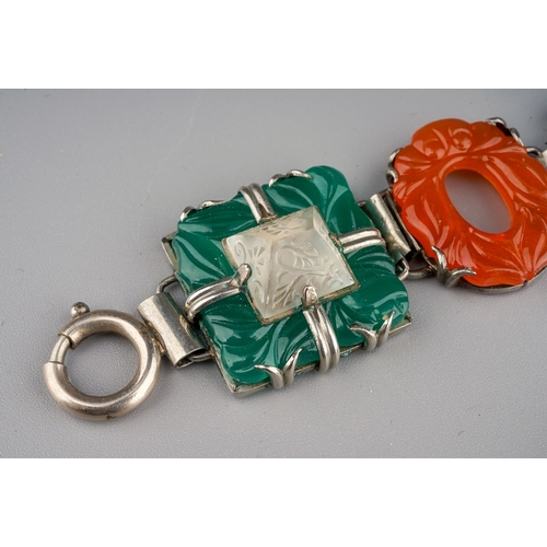 102 - A white metal a coloured paste bracelet, approx 20cm long; together with a carved green stone brooch... 