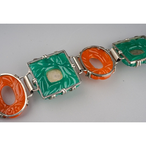 102 - A white metal a coloured paste bracelet, approx 20cm long; together with a carved green stone brooch... 